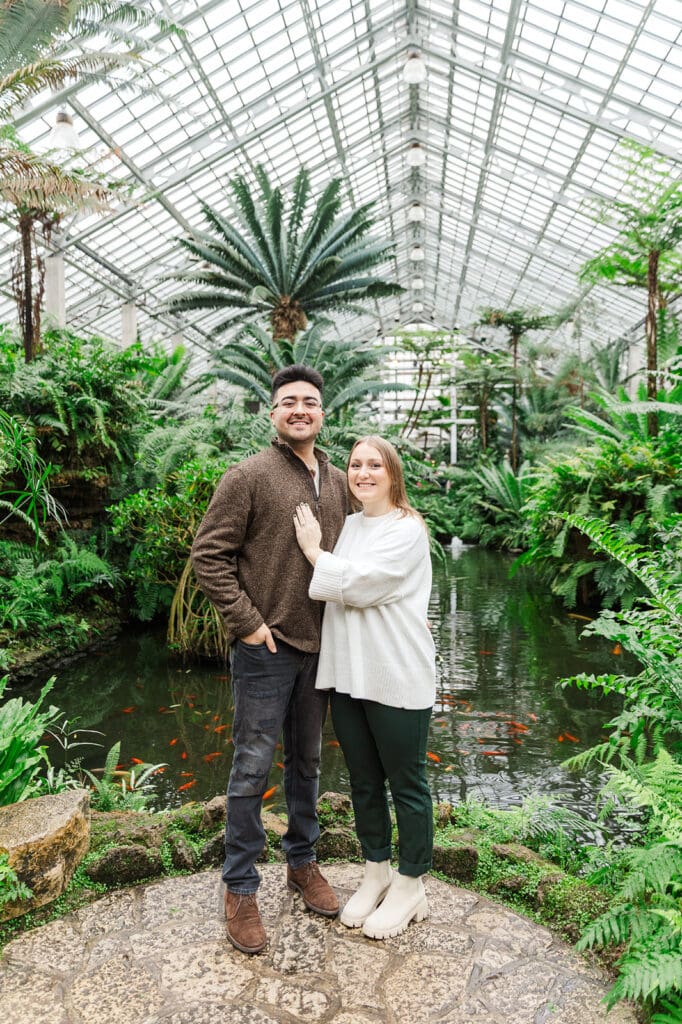 Couple standing together smiling during their Chicago engagement session at Garfield Park Conservatory.
