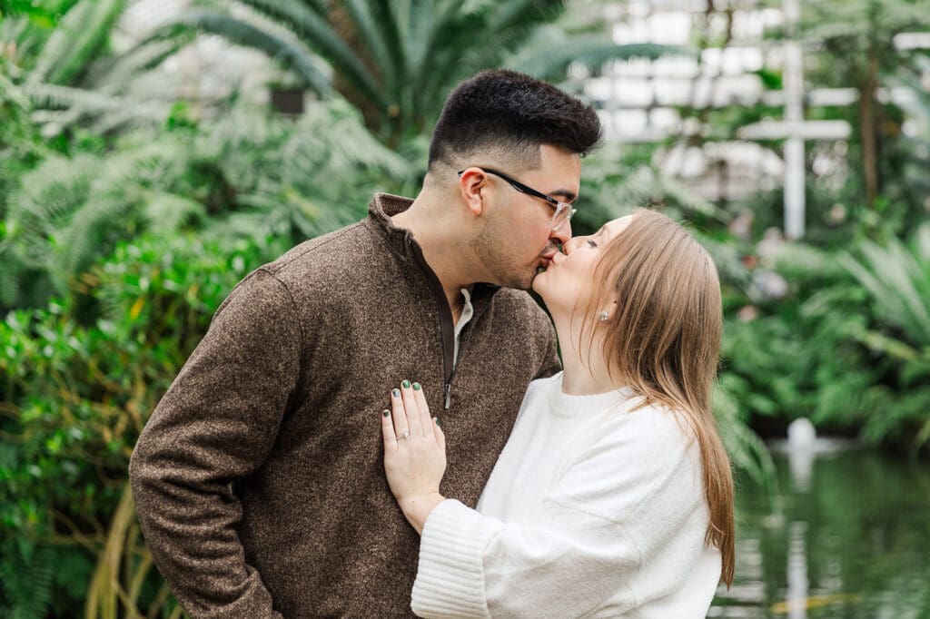 Couple sharing a sweet moment with a kiss during their Chicago Engagement session during the winter.