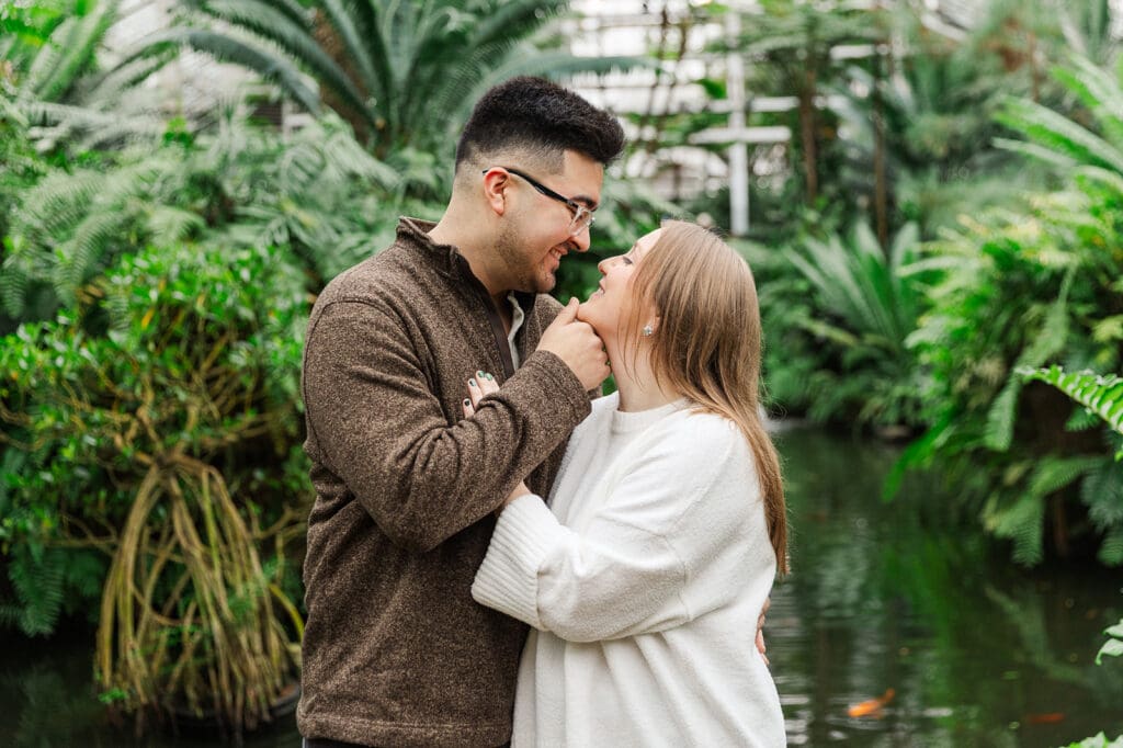 Couple sharing an intimate moment just before a kiss during their engagement session at Garfield Park Conservatory.