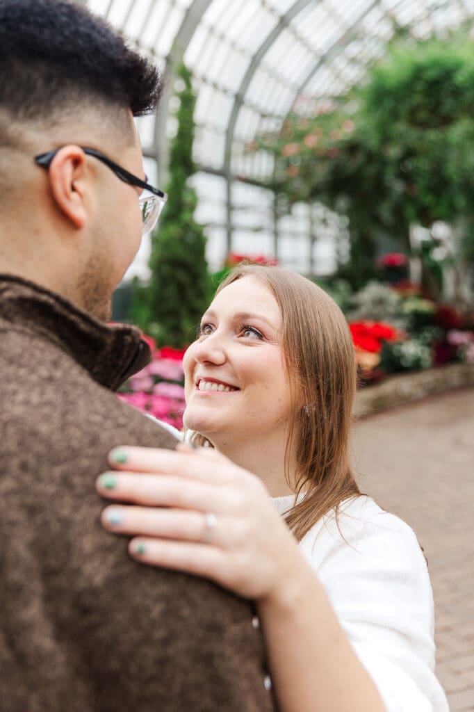 Couple standing looking at one another close up during their winter engagement session in Chicago