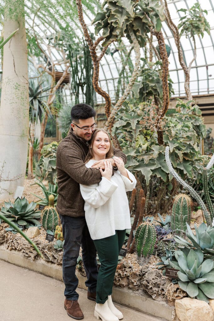 A couple standing together with their arms around one another during their Chicago engagement session