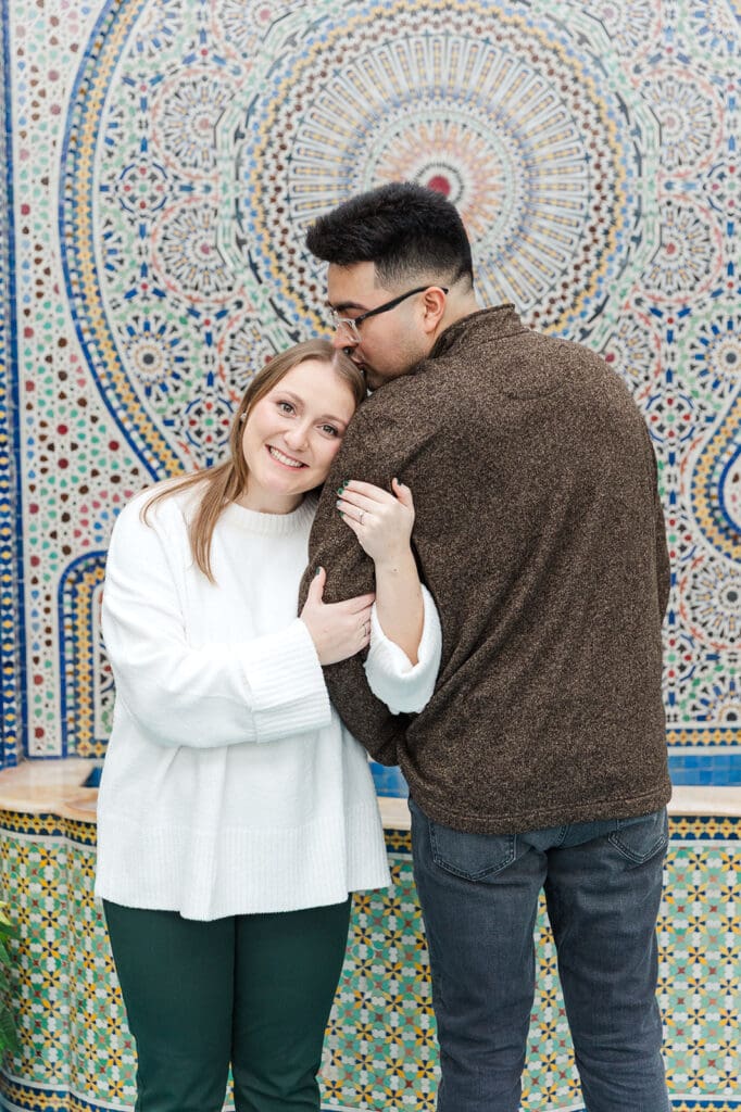 A couple cuddled up together at the mural located at Garfield Park Conservatory